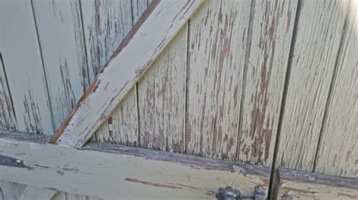 What causes paint to peel on wood